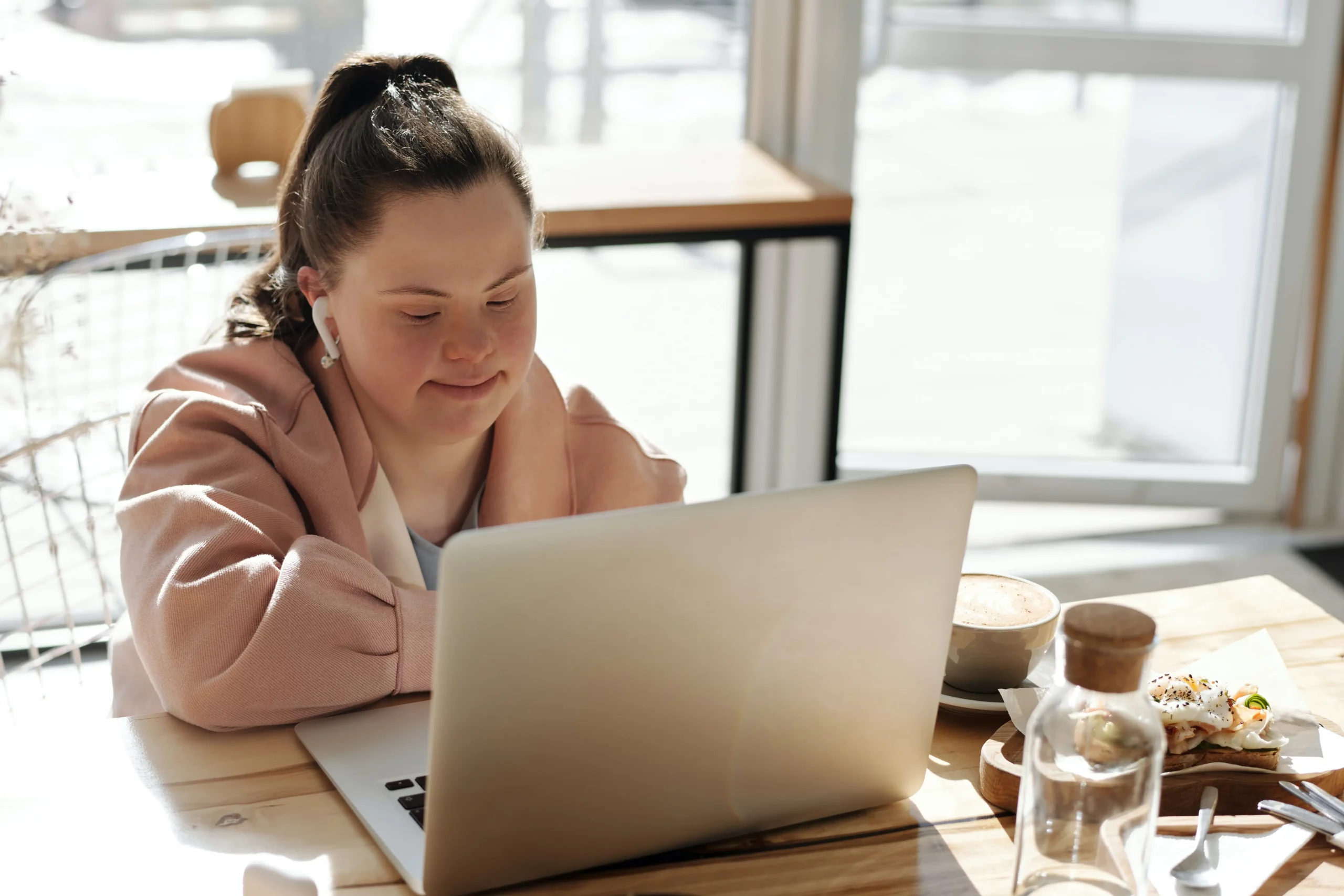 young adult girl with a disability working on computer